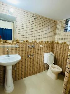 a bathroom with a toilet and a sink at Cheapest Apartment in Dhaka in Dhaka