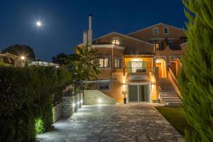 a house at night with the moon in the sky at Villa Bella Donna Corfu in Corfu