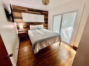 a small bedroom with a bed and a window at Creekside Haven in Gatlinburg