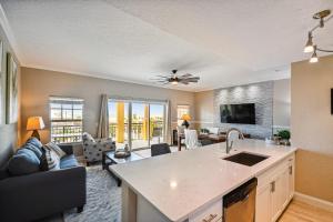 an open kitchen and living room with a couch at Treasure Island beach retreat in St Pete Beach