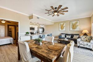 a dining room and living room with a table and chairs at Treasure Island beach retreat in St Pete Beach