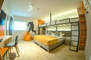 a bedroom with a bunk bed and a desk at Ice Premium Apartments in Veszprém