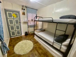 a dorm room with bunk beds and a rug at Global Star Chalet in Kampong Batang Tiga +19 photos