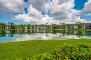 a view of a lake with apartment complexes at Naples Condo with Pool Access - 3 Mi to Beaches! in Naples