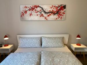 a bedroom with a bed and two tables with lamps at Appartement Am Weinberg in Radebeul