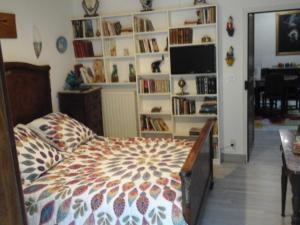 a bedroom with a bed and a book shelf at Mendiondo Gaü Eztia 
