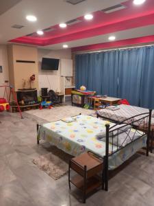 a room with two bunk beds and a flat screen tv at House marios airport in Spata
