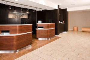 a lobby with a reception desk in a office at Courtyard by Marriott Charlotte Ballantyne in Charlotte