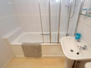 a bathroom with a bath tub and a sink at Primrose Cottage in Falmouth +30 photos