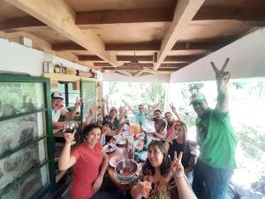 a group of people sitting around a table at Hostal Crisol in Refugio Lo Valdés