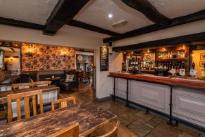 a restaurant with a bar with a table and chairs at The Strawbury Duck Inn in Darwen