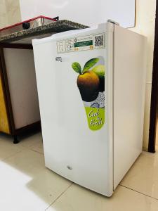 a white refrigerator with a picture of fruit on it at Cozy Studio Apartment 2 in Dubai