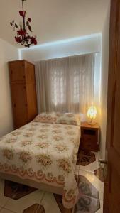 - une chambre avec un lit et une table avec une lampe dans l'établissement JPK Guest House, à Tiradentes