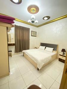 a bedroom with a bed in a room with at منتجع ليالي الحنين Layali Alhanin Resort in Al Hada