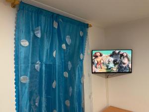 a tv hanging on a wall in a room at Piso cerca de la playa. in Melilla