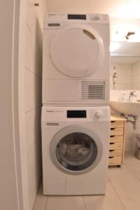 a washing machine in a bathroom with a sink at Holzhäuschen mit Pool 