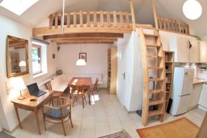 a kitchen and dining room with a loft bed at Holzhäuschen mit Pool 