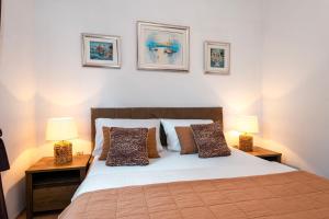 a bedroom with a large bed with two lamps at Villa StellaVita in Lozovac