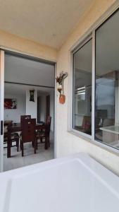 a room with a large window and a dining room at Apartamento en Guabinas Yumbo 