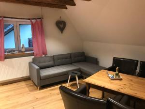 a living room with a couch and a table at Ferienwohnung im Berghüttenstyle in Bad Wörishofen