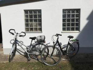 three bikes parked in front of a building at Ferienwohnung im Berghüttenstyle in Bad Wörishofen