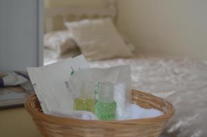 a basket with bottles in it on a bed at Witchingham B&B in Holyhead