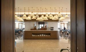 a lobby with a large chandelier hanging from the ceiling at Apec Nirvana Peace Mui Ne in Mui Ne +265 photos