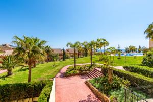 a park with palm trees and a pathway at Modern Apartment in Jardin Botanico in La Cala de Mijas