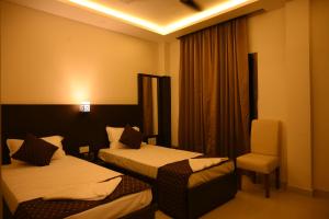 Hotel Tripti-Biswanath Chariali客房内的一张或多张床位