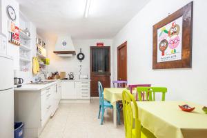 a kitchen with a table and chairs in a kitchen at Villa Carmen in Bocairent