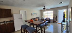 a kitchen and living room with a table and a refrigerator at Prime Location-Equipped House W Pool & Patios, Near the Beaches, Ideal for Small Families, Coastal Haven in Fort Lauderdale