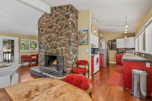 een keuken en een woonkamer met een stenen open haard bij Artsy Downtown Treehouse Perfect Flagstaff Location in Flagstaff