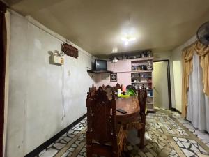 a dining room with a table and some chairs at King Henry's Transient House in Bantay
