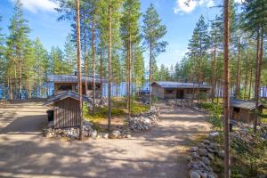 a set of three houses in the woods at Villa Ukkoteeri in Savonranta