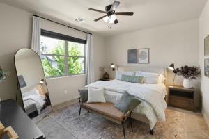 a bedroom with a bed and a ceiling fan at The Sage Wood House in Flagstaff