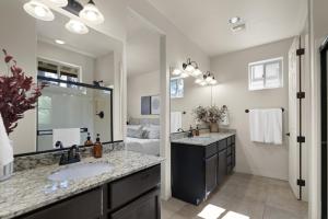 a bathroom with two sinks and a large mirror at The Sage Wood House in Flagstaff +38 photos