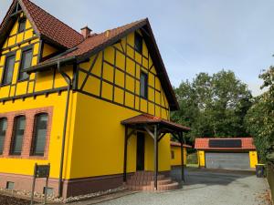 a yellow house with a brown roof at Neurenovierte FeWo Harztor in Nordhausen
