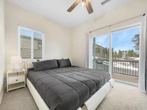a bedroom with a bed and a large window at Tiny Timber Tree Home NEW in Flagstaff