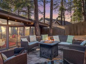 a patio with chairs and a fire pit in a yard at The Entertainer Luxury In The Heart of Flagstaff in Flagstaff