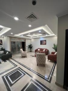 a lobby with couches and chairs in a building at Villa in Allegria El Sheikh Zayed in Sheikh Zayed