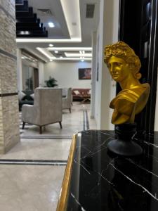 a gold head on a table in a lobby at Villa in Allegria El Sheikh Zayed in Sheikh Zayed