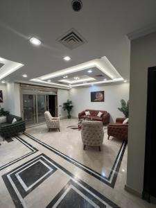 a lobby with couches and chairs in a building at Villa in Allegria El Sheikh Zayed in Sheikh Zayed
