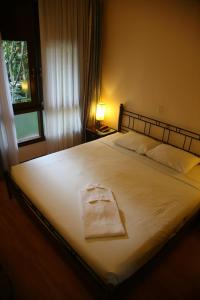 a bedroom with a bed with a towel on it at Mui Ne Resort in Mui Ne