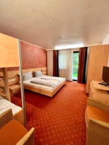 a hotel room with a bed and a window at Terra Ventura Hotel in Gondorf