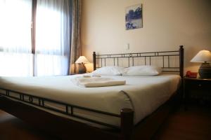 a bedroom with a bed with two towels on it at Mui Ne Resort in Mui Ne +115 photos