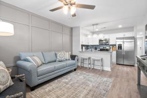 a living room with a couch and a kitchen at Modern 3-bedroom Close To Ft, Campbell in Clarksville