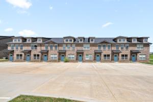 an empty parking lot in front of a large brick building at Modern 3-bedroom Close To Ft, Campbell in Clarksville