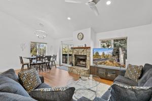 a living room with a couch and a fireplace at Brand New Listing Country Club Condo in Flagstaff