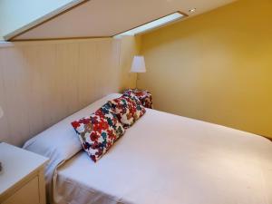 a bedroom with a bed with a pillow on it at El Ático in Tordesillas