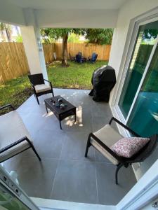 a patio with two chairs and a coffee table at Mango Tree House in Lake Worth